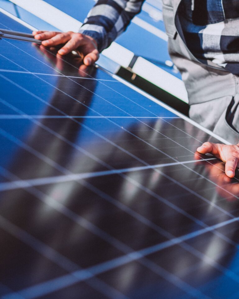 man worker in the firld by the solar panels